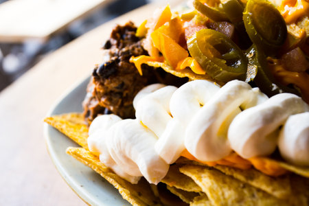 Nachos with guacamole. Nachos are a dish of Mexican origin, which consists of frying pieces of corn tortilla covered with a special cheese.の写真素材