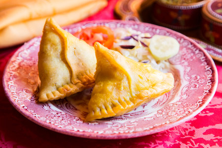 Samosa is a fried or baked dumpling with savory filling, such as seasoned potatoes, onions, peas,...