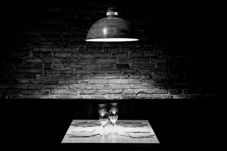 Elegant restaurant table with cutlery, crockery and glasses.