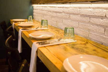 Elegant restaurant table with cutlery, crockery and glasses.