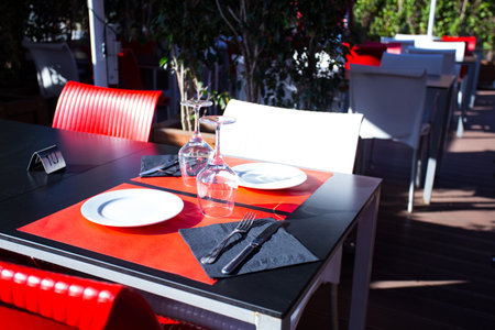 Elegant restaurant table with cutlery, crockery and glasses.の写真素材