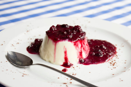 Cheesecake with red fruit sauce and fresh fruit such as raspberries, blueberries or strawberries.の写真素材
