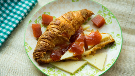 Croissant with cheese and quince jamの写真素材