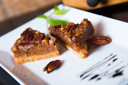 Dark chocolate dessert with nuts in a French patisserie.の写真素材