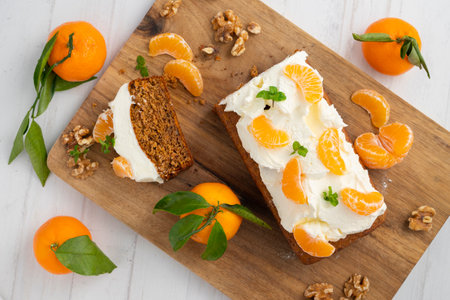 Carrot cake with white frosting and tangerine piecesの写真素材