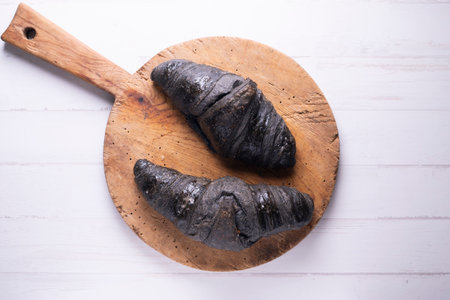 Croissant made with activated charcoal. Vegan breakfast.の写真素材