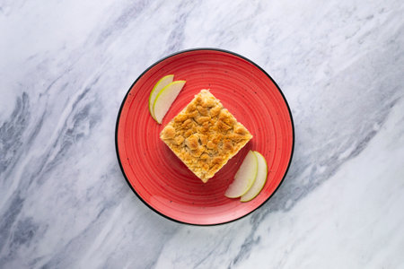 Apple Crumble. The crumble is a cake with fruits. It is made with various fruits that are covered with a dough of flour, butter and sugar.の写真素材