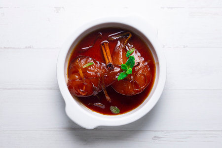 Pears cooked in red wine with orange.の写真素材