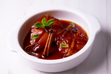 Pears cooked in red wine with orange.の写真素材