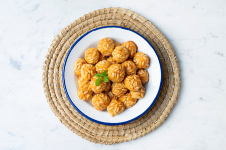 <p>Penellets. Small sweets of various shapes, made from almond and potato dough, and covered with...