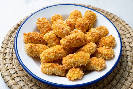 Penellets. Small sweets of various shapes, made from almond and potato dough, and covered with almonds or pine nuts.の写真素材