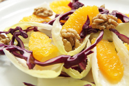Endive salad with orange and walnuts.の写真素材