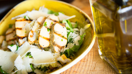 A Caesar salad is a salad of romaine lettuce, croutons, and chicken with lemon juice, olive oil, egg, Worcestershire sauce, anchovies, garlic, Dijon mustard, Parmesan cheese, and bの写真素材