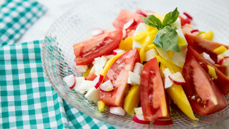 Delicious salad with mango and tomatoes.の写真素材