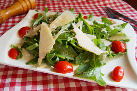 Delicious salad fresh ingredients, tomatoes and arugula.の写真素材