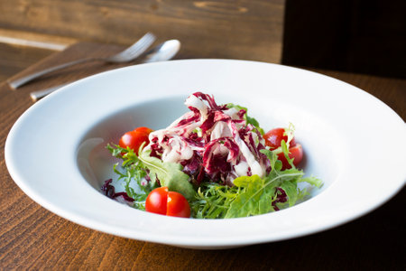 Delicious salad fresh ingredients, tomatoes and arugula.の写真素材