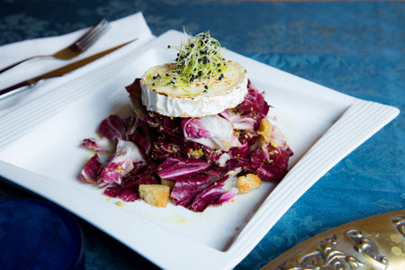 Delicious and healthy green salad with gratin goat cheese.の写真素材