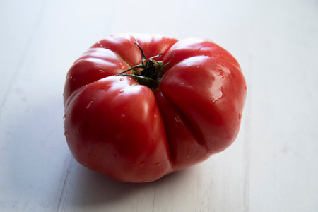 Organic fresh tomato on a white wooden background.の写真素材
