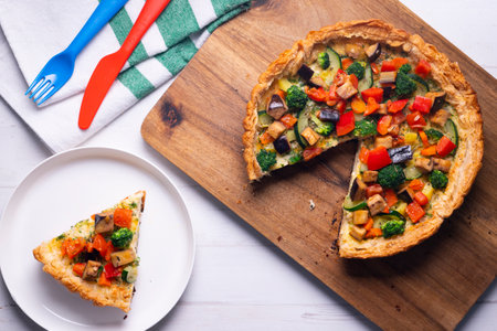Vegetarian tart with broccoli, pepper and zucchini in puff pastry.の写真素材
