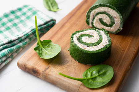 Spinach tortilla roll stuffed with ham and cream cheese.の写真素材