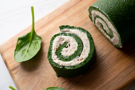 Spinach tortilla roll stuffed with ham and cream cheese.の写真素材