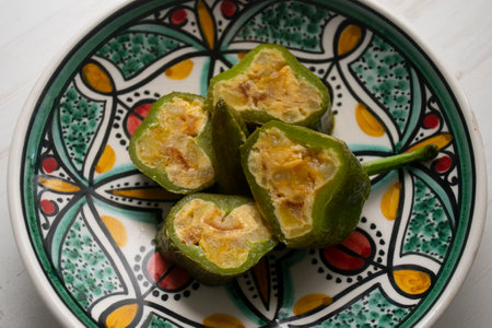 Italian green peppers stuffed with potato omelette with egg. Traditional Spanish tapa recipe.の写真素材