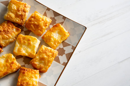 Small, square puff pastries with gratin cheese.の写真素材