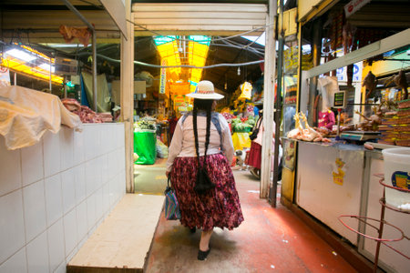 Puno, Peru; 1st January 2023: A woman walking through the central food market of the city of Puno in Peru.のeditorial素材