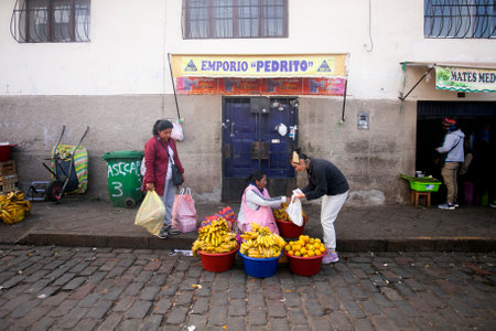 Cusco Peru, 1st January 2023: Locals selling fruits and vegetables around the central market of Cusco in Peru.のeditorial素材