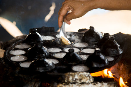 Woman preparing coconut thai desserts. Kanom krok is a tasty Thai coconut milk based mini pancakes...
