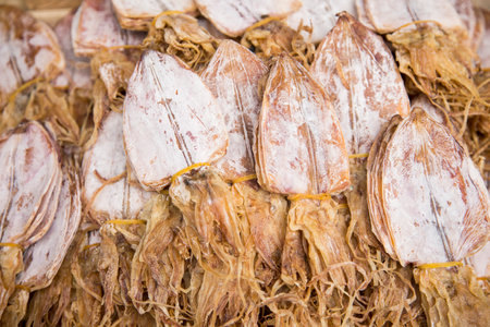 Dried squid at a food stall on the streets of Bangkok, Thailand.の写真素材