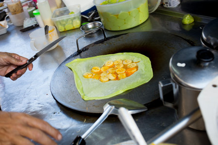 Green pancakes with banana at a street food stall in Bangkok, Thailand.の写真素材