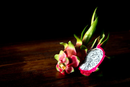 Pitahaya or dragon fruit on a wooden table with a dark background.の写真素材