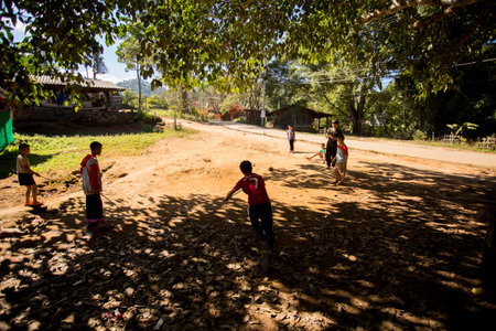Chiang Mai, Thailand; 1st January 2023: A group of young people playing on the streets of a village in the mountains of Chiang Mai.のeditorial素材