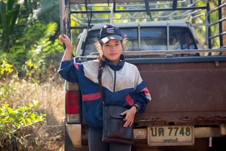 Samut Songkhram, Thailand; 1st January 2023: A young female farmer working on an organic coconut plantation.のeditorial素材