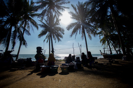 Sichon, Thailand; 1st January 2023: Sellers and buyers at the fish market on Sichon beach.のeditorial素材