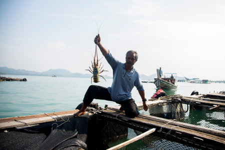 Koh Yao, Thailand; 1st January 2023: Local fisherman at a lobster farm on an island in southern Thailand.のeditorial素材