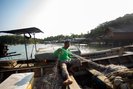 Koh Yao, Thailand; 1st January 2023: Fisherman in Koh Yao fishing village preparing nets to catch fish.のeditorial素材