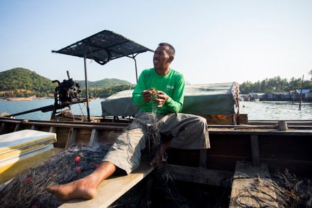 Koh Yao, Thailand; 1st January 2023: Fisherman in Koh Yao fishing village preparing nets to catch fish.のeditorial素材