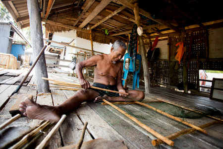Koh Yao, Thailand; 1st January 2023: Fisherman in Koh Yao fishing village preparing nets to catch fish.のeditorial素材