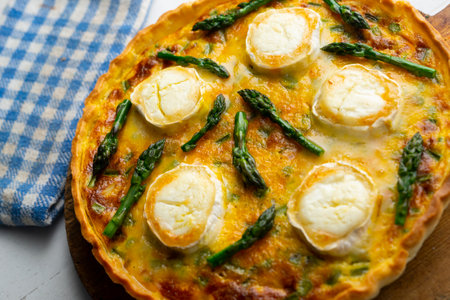 French style quiche with green asparagus, eggs, and slices of goat cheese.の写真素材
