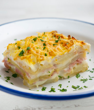 Potato and bechamel lasagna. Recipe with ham and grilled cheese.の写真素材
