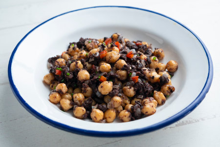 Stewed chickpeas with black pudding and red pepper. Traditional tapas from Barcelona.の写真素材