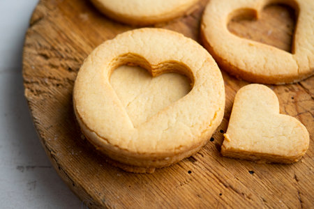Preparing butter cookies for children with star and heart shapes.
