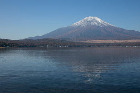 Views of Mount Fuji covered in snow from Yamanaka lake in Yamanakako, Japan.の写真素材