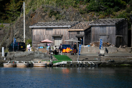 Shukunegi, Japan; 1st October 2023: A group of tourists enjoying a Tarai Bune or tub boat tour along Ogi Coast.のeditorial素材