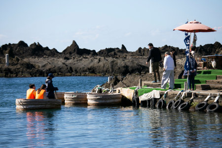 Shukunegi, Japan; 1st October 2023: A group of tourists enjoying a Tarai Bune or tub boat tour along Ogi Coast.のeditorial素材