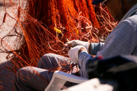 Fishermen mending their fishing nets at Katsuura Harbor in Wakayama.の写真素材