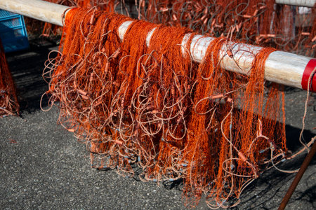 Fishermen mending their fishing nets at Katsuura Harbor in Wakayama.の写真素材