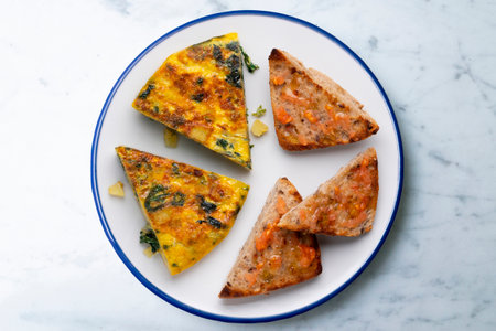 Spanish potato omelette with spinach. Traditional tapa.